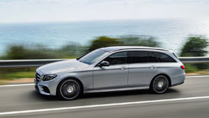 A sleek Mercedes E-Class Station Wagon W213 cruising along the scenic coastline on a sunny day.
